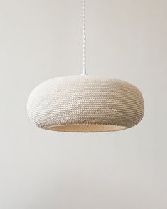 a white light hanging from a ceiling