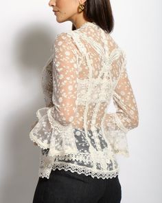 The Colette lace blouse features a delicate fitted V neckline top with ¾ sleeves and Venise lace collage all thru-out. The Colette comes with a lace bralette. Cotton and Rayon tulle lace Five satin buttons along bustline center front Dry clean only Each piece is made to order and handcrafted in our atelier. Slight variations may occur as each piece is unique. Spring Lace Blouse With 3/4 Sleeves, Lace Blouse With 3/4 Sleeves For Spring, Lace Blouse With Three-quarter Sleeves For Spring, Elegant Sheer Lace Blouse, Elegant Sheer Lace Top, Sheer Feminine Lace Top, Feminine Fitted Lace Top With Delicate Lace, Fitted Long Sleeve Lace Top With Delicate Lace, Fitted Feminine Lace Top