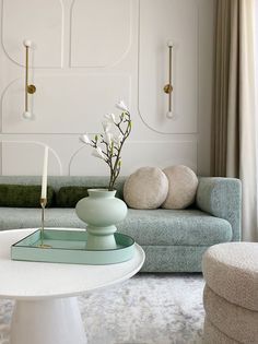 a living room filled with furniture and a white table in front of a blue couch