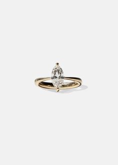 a yellow gold ring with a pear shaped diamond