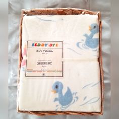 a baby blanket in a box with a rubber ducky design on it's side