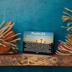 a wooden shelf topped with two stuffed animals next to a sign that reads, psalm 23