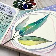 an open book with watercolors and writing on it