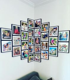 a room with pictures hanging on the wall and a couch in front of it,