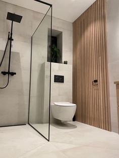 a bathroom with a toilet, shower and sink in it's center wall area