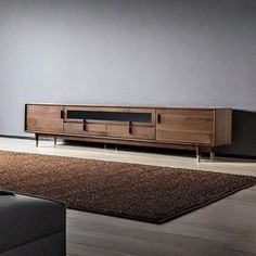 a living room scene with focus on the entertainment center and rugs in the foreground