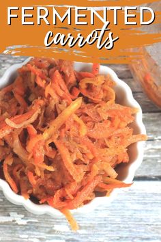 a bowl filled with shredded carrots on top of a wooden table