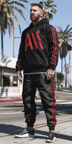 a man in black and red tracksuits standing on the street with his skateboard