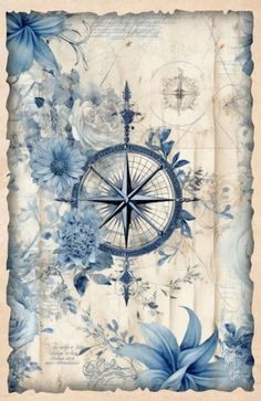 a compass with blue flowers and leaves on the cover of an old paper sheet that has been