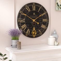 there is a large clock on the wall next to a vase with flowers in it