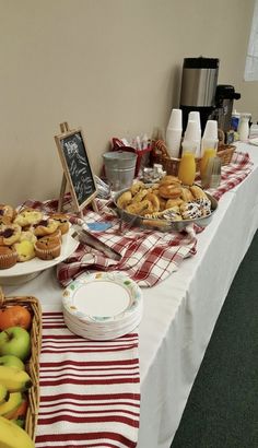 a table topped with lots of food next to a white table cloth covered tablecloth