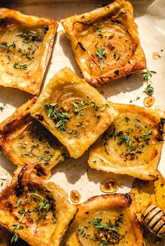 some food that is sitting on top of a pan with honey and herbs in it