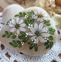 a rock with flowers painted on it