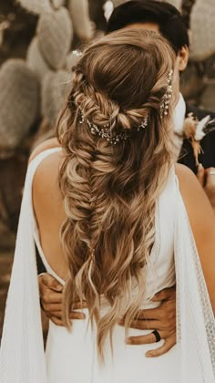 the back of a bride's head with her hair in a braid