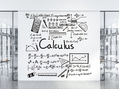 a wall that has some writing on it and there is a calculator drawn on it