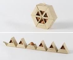 three different angles of an origami box with eggs in it and four smaller ones on the bottom