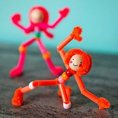 two toy figurines sitting on top of a table