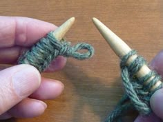 two hands are holding yarn and crocheting together