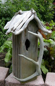 a bird house made out of wood and branches