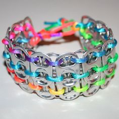 there is a bracelet made out of metal chains and colorful beads on the inside of it