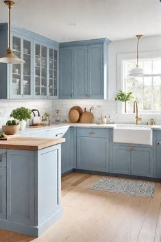 a kitchen with blue cabinets and wooden floors