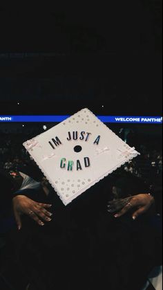 a graduate's cap with the words i'm just a grad written on it