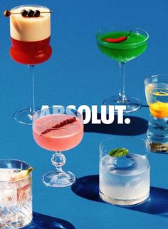 four different types of cocktails with the words absolut above them on a blue background