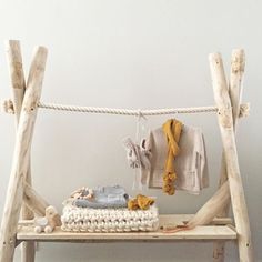 a wooden bench with clothes and shoes on it