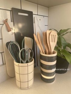 kitchen utensils and spoons are sitting on the counter