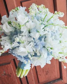 a bouquet of white and blue flowers on a door