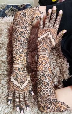 the hands and feet of a woman with henna tattoos