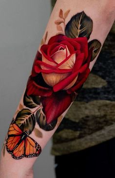 a rose and butterfly tattoo on the arm