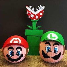 two paper mario brothers pumpkins sitting next to each other