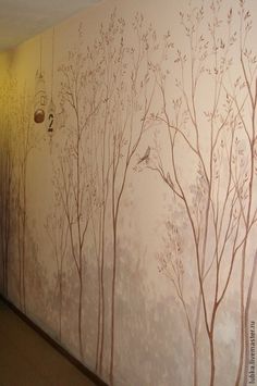 the wall is painted with trees and birds