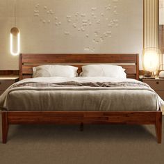 a large bed sitting next to two lamps on either side of the headboard and foot board