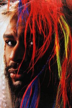 a man with long hair and multicolored dreadlocks