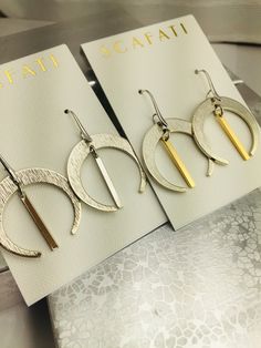 "Simple large crescents that are a glossy silver and will work with almost any occasion. The silver is a glossy silver alloy plated over brass which is a mix of different base metals. The finish is glossy because it is rack plated. This means that pieces are hand hung so they receive the optimal amount of coverage. The gold is an 18 K gold plating over brass. The earrings are lead safe. You have a choice of two different combinations. 1) Gold and Silver 2) Silver The earrings are 1 & 1/4\" i Nickel-free Crescent Earrings For Everyday Wear, Everyday Crescent Nickel-free Earrings, Everyday Nickel-free Crescent Earrings, Modern Crescent Hoop Earrings, Pierced, Everyday Metal Crescent Earrings, Modern Crescent Hoop Earrings, Modern Crescent Shaped Pierced Hoop Earrings, Everyday Crescent Metal Earrings, Modern Crescent-shaped Hoop Earrings