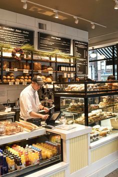 a man working at a counter in a bakery