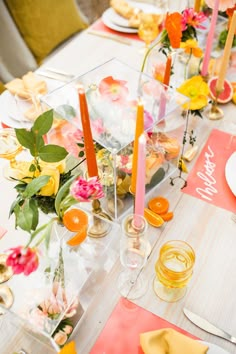 the table is set with flowers and candles