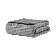 two gray towels stacked on top of each other in front of a white background and one folded