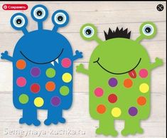 two paper monsters with polka dots on them, one is green and the other is blue