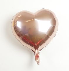 a heart shaped foil balloon hanging from the ceiling