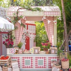 an outdoor stand with various fruits and vegetables on it