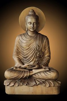 a buddha statue sitting on top of a wooden block