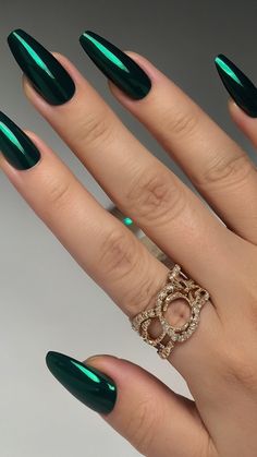 Indulge in the allure of dark emerald green nails with intricate acrylic coffin designs like French tips silver chrome and elegant almond shapes Discover short gold and simple acrylic almond designs for prom nights or shellac finish Accentuate your style with acrylic coffin prom nail art in radiant green hues