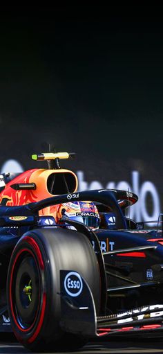 two red and black race cars driving on a track with the word roma in the background