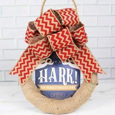 a burlock wreath with the words hark hanging from it's front