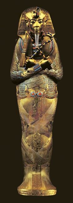 an egyptian statue is shown in gold and black