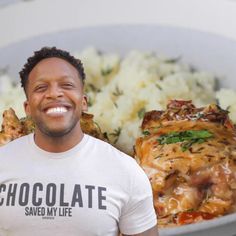 a man standing in front of a plate of food with chicken and rice on it