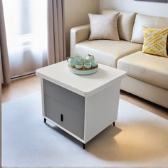 a living room scene with focus on the coffee table and white couch in the background